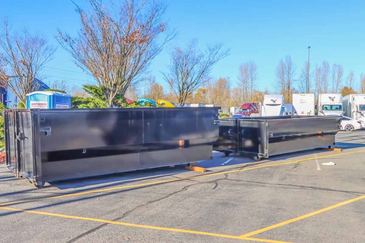 Professional dumpster rental service with roll-off container on residential driveway in Acworth
